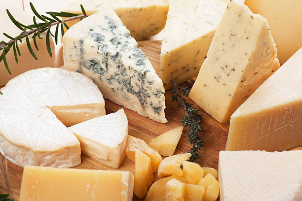 Assorted cheese on wooden platter stock photo