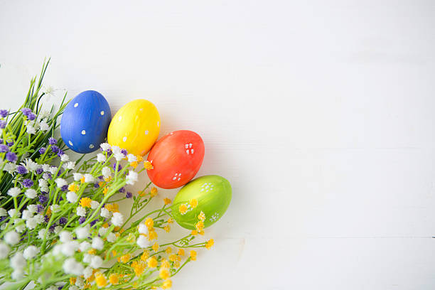 istock Colorful decorated easter eggs on white wood background. 513810530