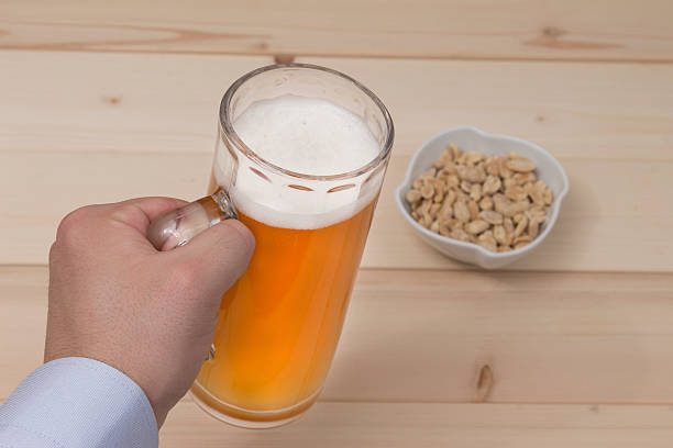 istock Male hand holding a mug of draft beer 513811008