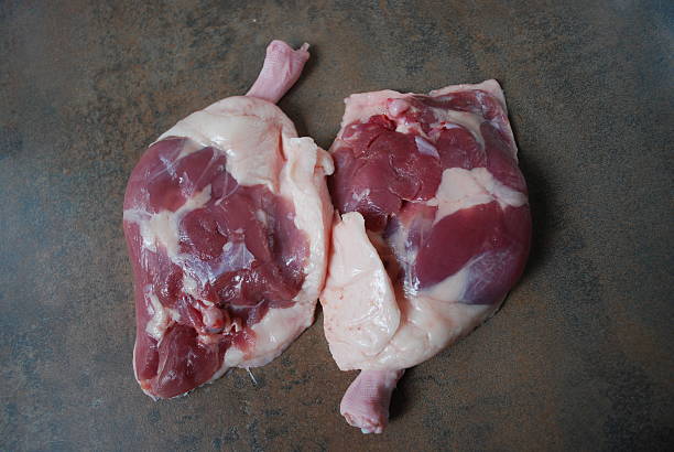 istock Fresh duck legs on the wooden table. 513813070