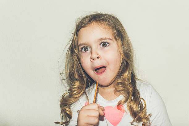 istock Funny girl holding grissini and making a face 513813528