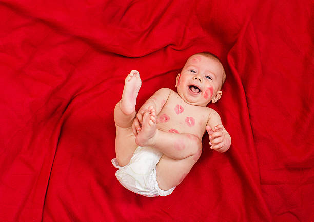 istock cute baby covered with kisses 513813728
