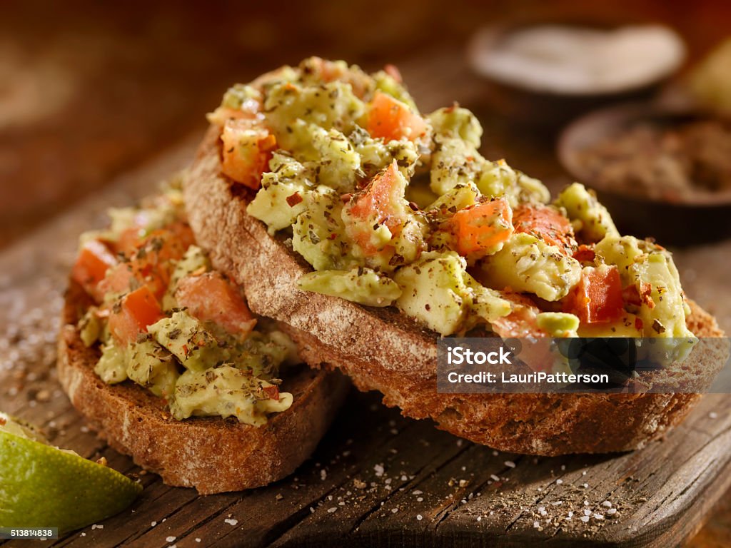 Avocado Toast with Tomatoes on Rye Bread Avocado Toast with Tomatoes on Rye Bread -Photographed on Hasselblad H3D2-39mb Camera Toasted Bread Stock Photo