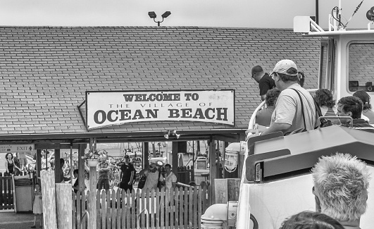 Ocean Beach, NY, USA - August 12, 2009: Tourists, beach-goers and residents arrive by ferry to gateway to Fire Island, in the summer of 2009.