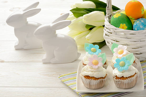 istock Easter table - basket with eggs, muffins and bunnies. 513817540