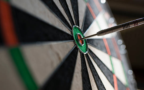istock Single dart hitting bull's eye on the dartboard 513818410