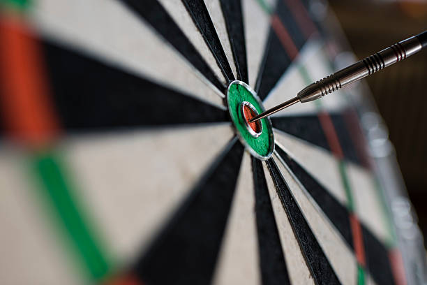 istock Single dart hitting bull's eye on the dartboard 513818444