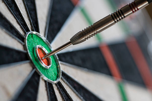 istock Single dart hitting bull's eye on the dartboard 513818546