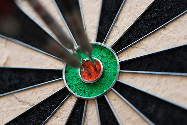 istock Darts hitting bull's eye on the dartboard 513818690