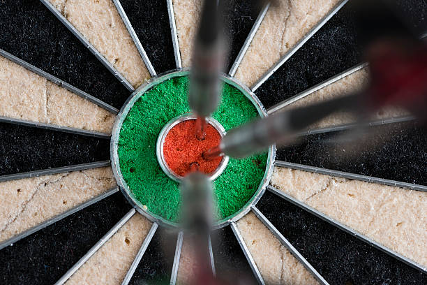 istock Darts hitting bull's eye on the dartboard 513819088