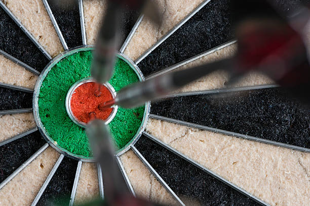 istock Darts hitting bull's eye on the dartboard 513819140