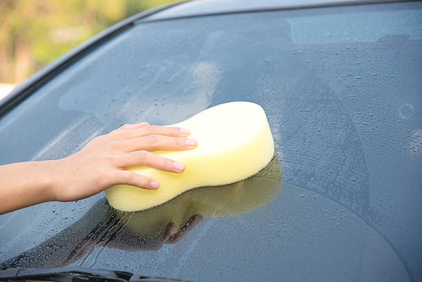 istock Cleaning windscreen of a car 513819548