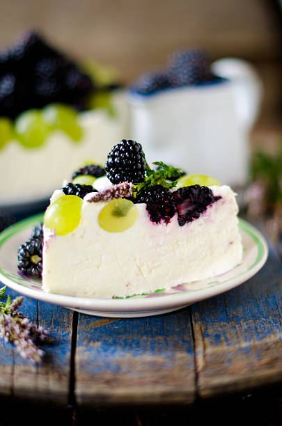 istock Cheesecake with blackberries and grapes on a wooden table old 513821351