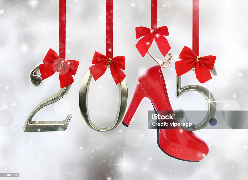High heel shoe and 2015 number hanging on red ribbons High heel shoe and 2015 number hanging on red ribbons in a glittery background 2015 Stock Photo