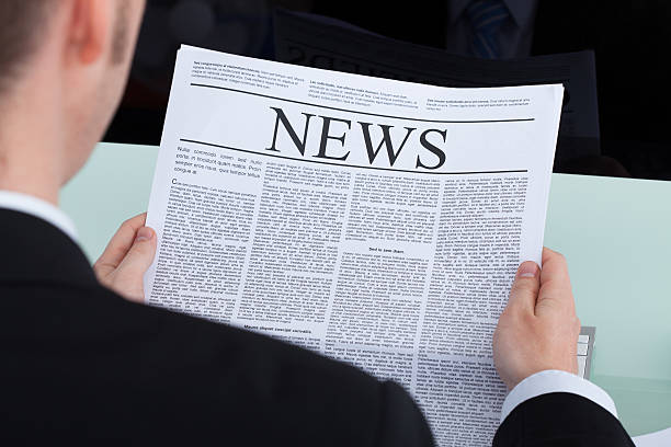 istock Businessman Reading Newspaper At Office Desk 513821919