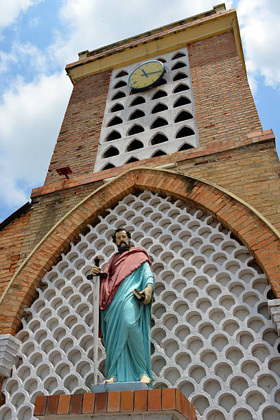 Brazzaville, Congo: Cathedral of the Sacred Heart - clock tower and St Paul with a large sword on the facade - Cathédrale du Sacré Cœur / Cathédrale Saint Firmin (1892) - designed by Monseigneur Augouard - Quartier de l'Aiglon - photo by M.Torres