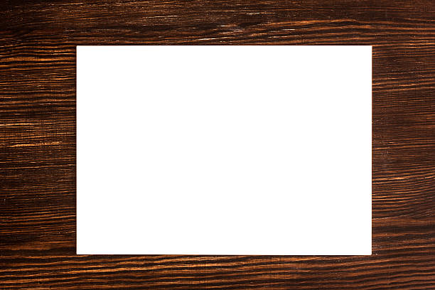 istock White card on wooden desk 513826295