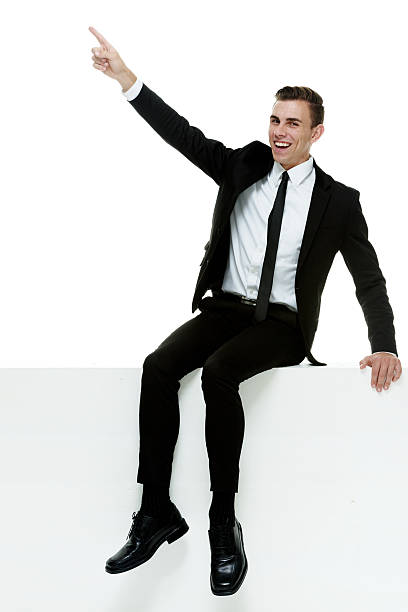 istock Cheerful businessman on box & pointing away 513827965