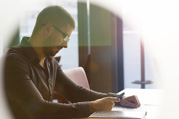 istock Young man looking at the phone, window view 513828005