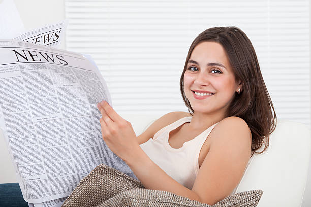 istock Woman Reading Newspaper At Home 513828299