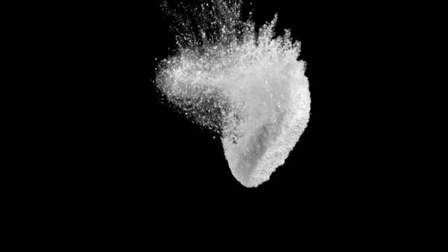 SLO MO Fizzing tablet dissolving in water on black background