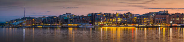 istock Oslo waterfront restaurants Aker Brygge illuminated at dusk panorama Norway 513847767