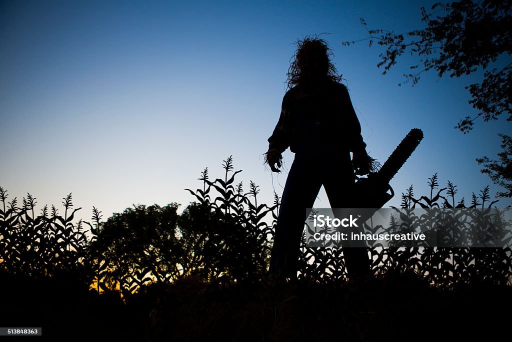 Silhouette of a Scarecrow in cornfield Chainsaw Stock Photo