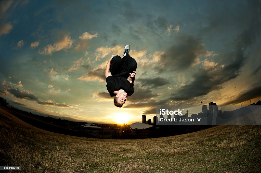 Backflip Parkour A man backflipping doing parkour / free running with the city outline in the background Backflipping Stock Photo