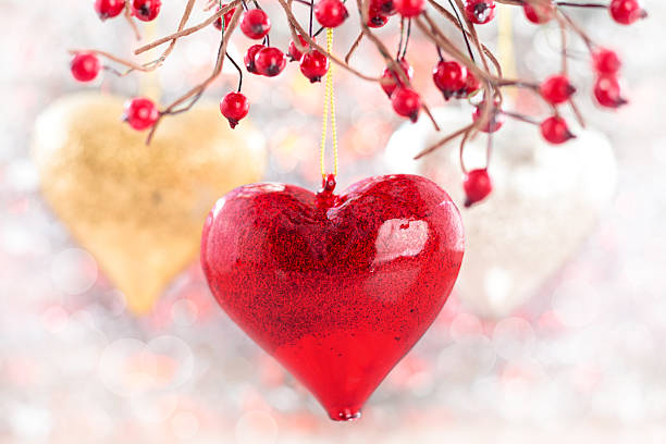 istock Three hearts against holiday lights. 513849117