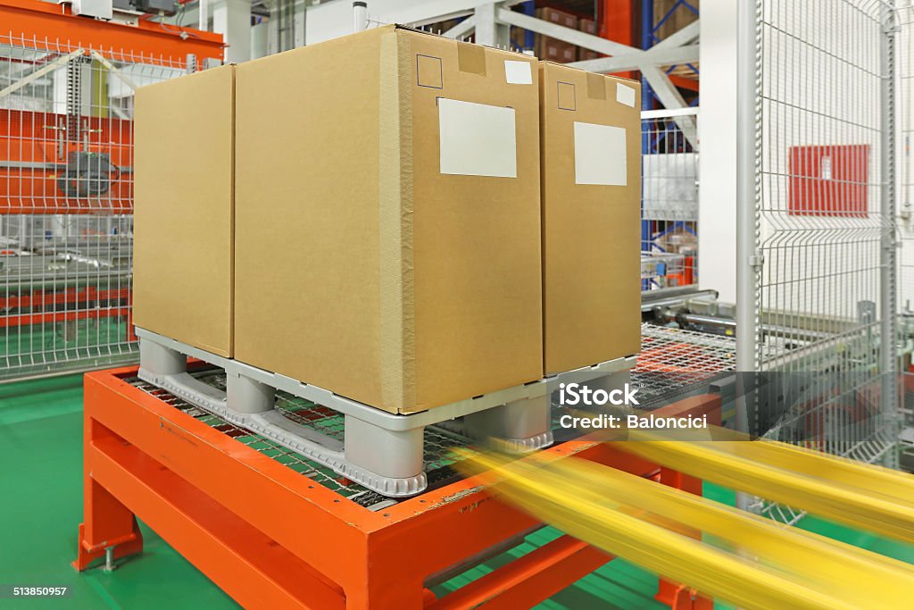 Pallet Pallet with boxes at automated storage and retrieval system in warehouse Conveyor Belt Stock Photo