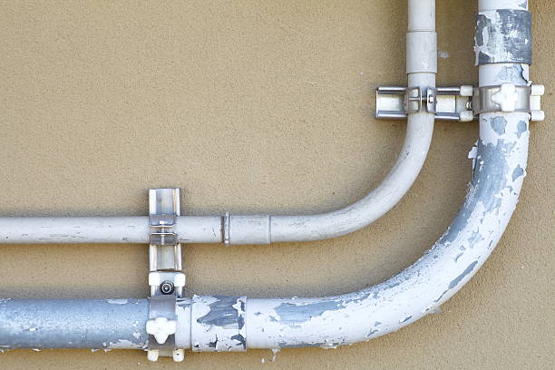 istock Close - up Metallic pipe on brown concrete wall 513852931