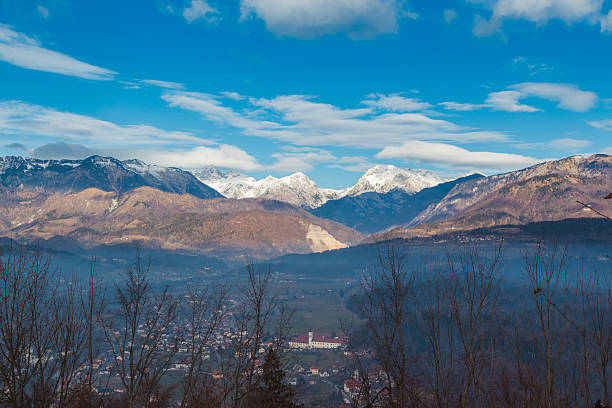 Alps and town below. Kamnik-Savinja Alps winter view from Old Castle on a hill. krvavec stock pictures, royalty-free photos & images