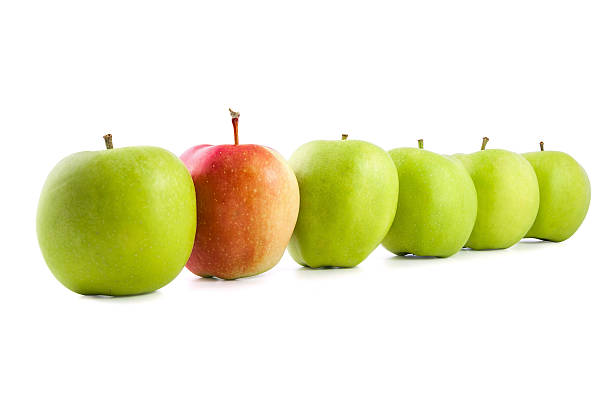 istock Red apple in a row of green apples 513872568