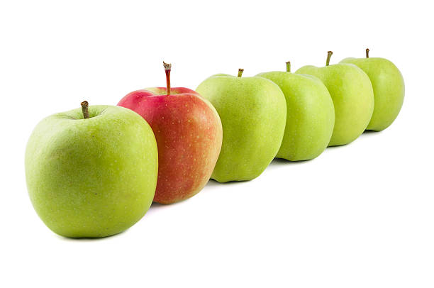 istock Red apple in a row of green apples 513872588