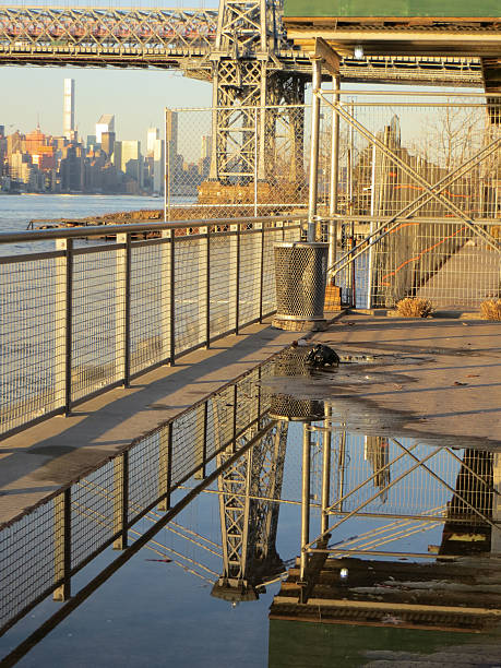 istock Williamsburg-Bridge mirrored in puddle of water on Schaefer's Esplanade 513874634