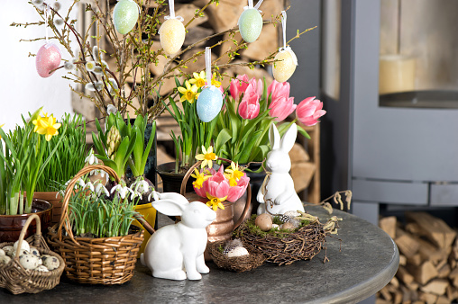 Easter decoration with flowers and eggs. Tulips, snowdrops and narcissus blooms on white background. Selective focus