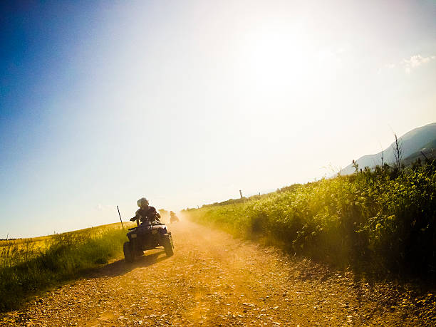 istock two guys on quad bikes in mountain trail 513878086