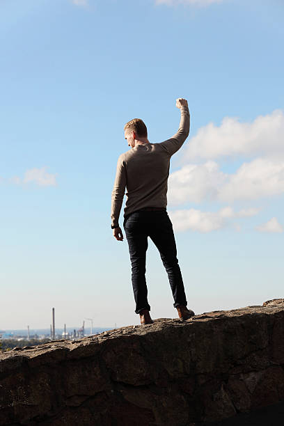 istock Man on top of mountain cityscape 513879006