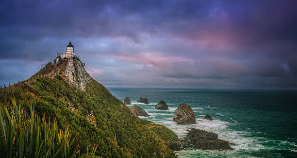 istock Lighthouse Overlooking Nugget Islands At Kaka Point, Catlins 513881010