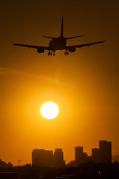 istock Airliner descending into Sky Harbor Airport at Sunset. 513881052