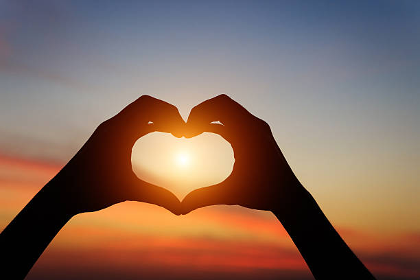 istock silhouette hand gesture feeling love during sunset 513882332