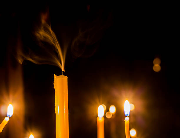 istock Yellow candle on the background with smoke 513883017