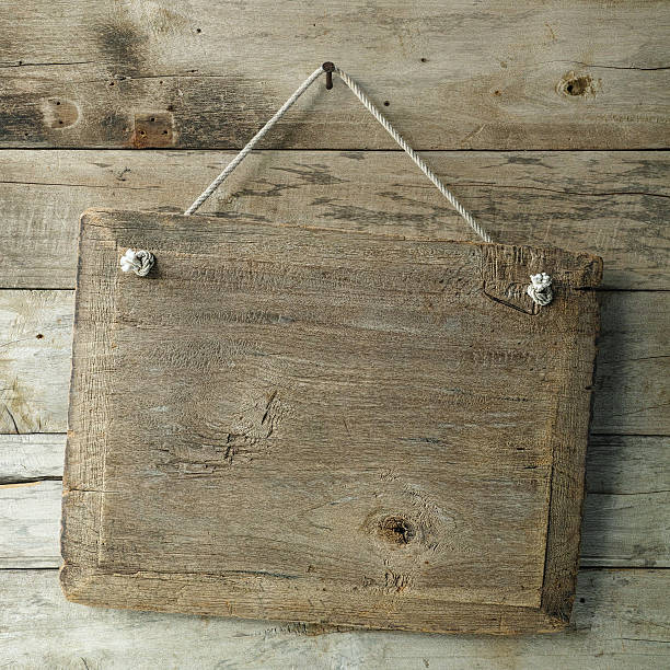 istock Old weathered wood signboard hanging from an old nail. 513883076