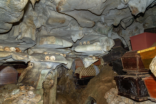 Skulls and coffins in cave. Londa is cliffs and cave old burial site in Tana Toraja. Galleries of tau-tau on balcony guard the graves. Inside there's a collection of coffins. South Sulawesi, Indonesia