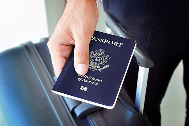 Hand holding U.S. passport Hand holding U.S. passport passport stock pictures, royalty-free photos & images