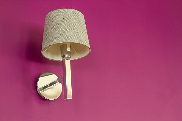 beige lamp on pink wall background