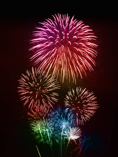 Colorful Firework Display on Night Sky Colorful firework display, isolated on black background. firework display pyrotechnics celebration excitement stock pictures, royalty-free photos & images