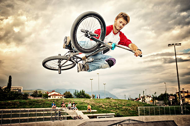 BMX rider BMX rider in performing tricks. levitation stock pictures, royalty-free photos & images