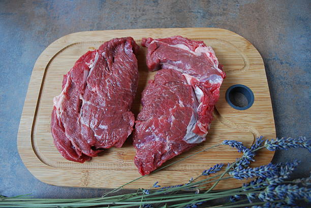 istock Fresh beef steak on a cutting board and lavender branch. 513886938