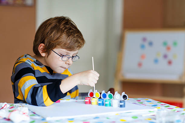 istock Little kid boy drawing with colorful watercolors indoors 513891736